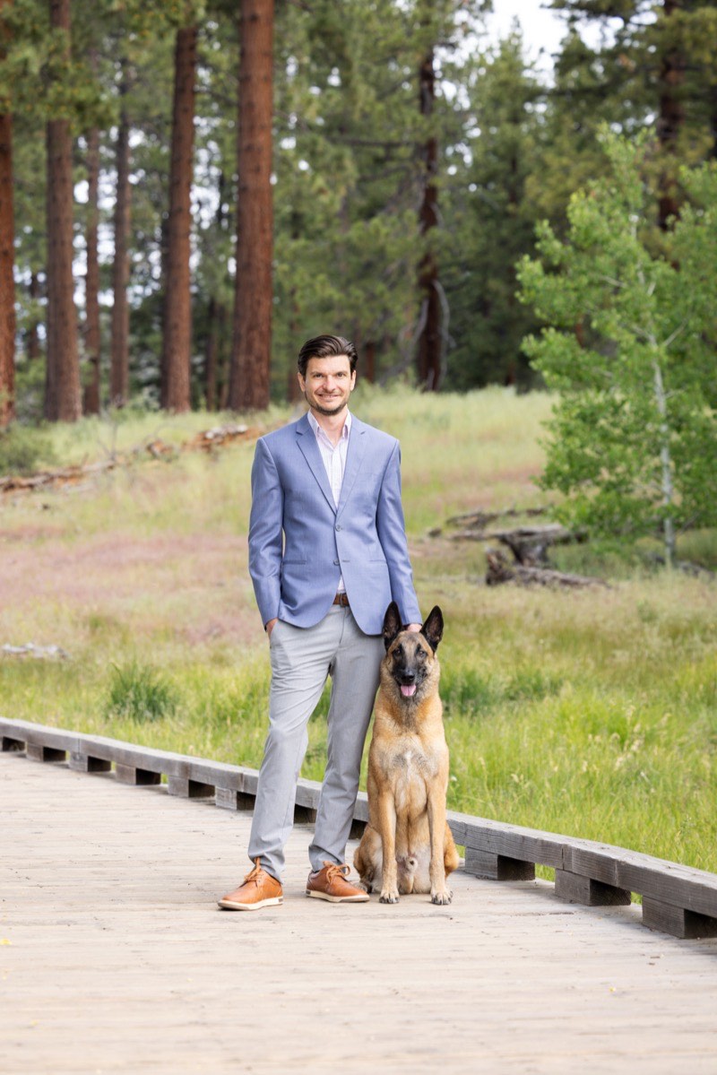 Cooper Townsend, Founder of Intragreat Consulting, with his dog on a boardwalk in South Lake Tahoe